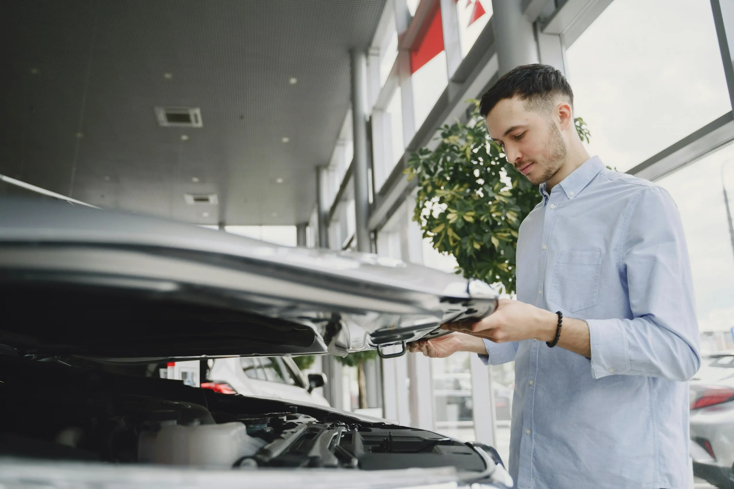 Customer inspecting a clean rental car